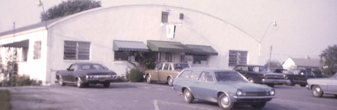 Old photo of Good's Store with cars parked in the front