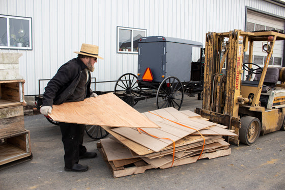 Amish man loading buggy
